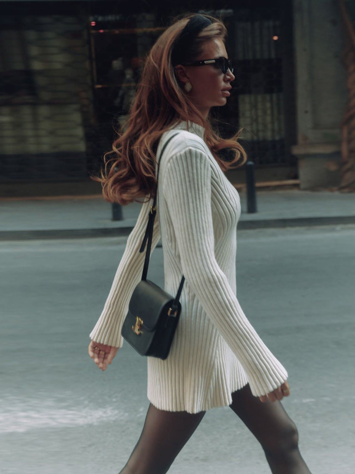 Long sleeved tight knit dress with a semi high collar and a base that covers the hips a solid color woolen dress