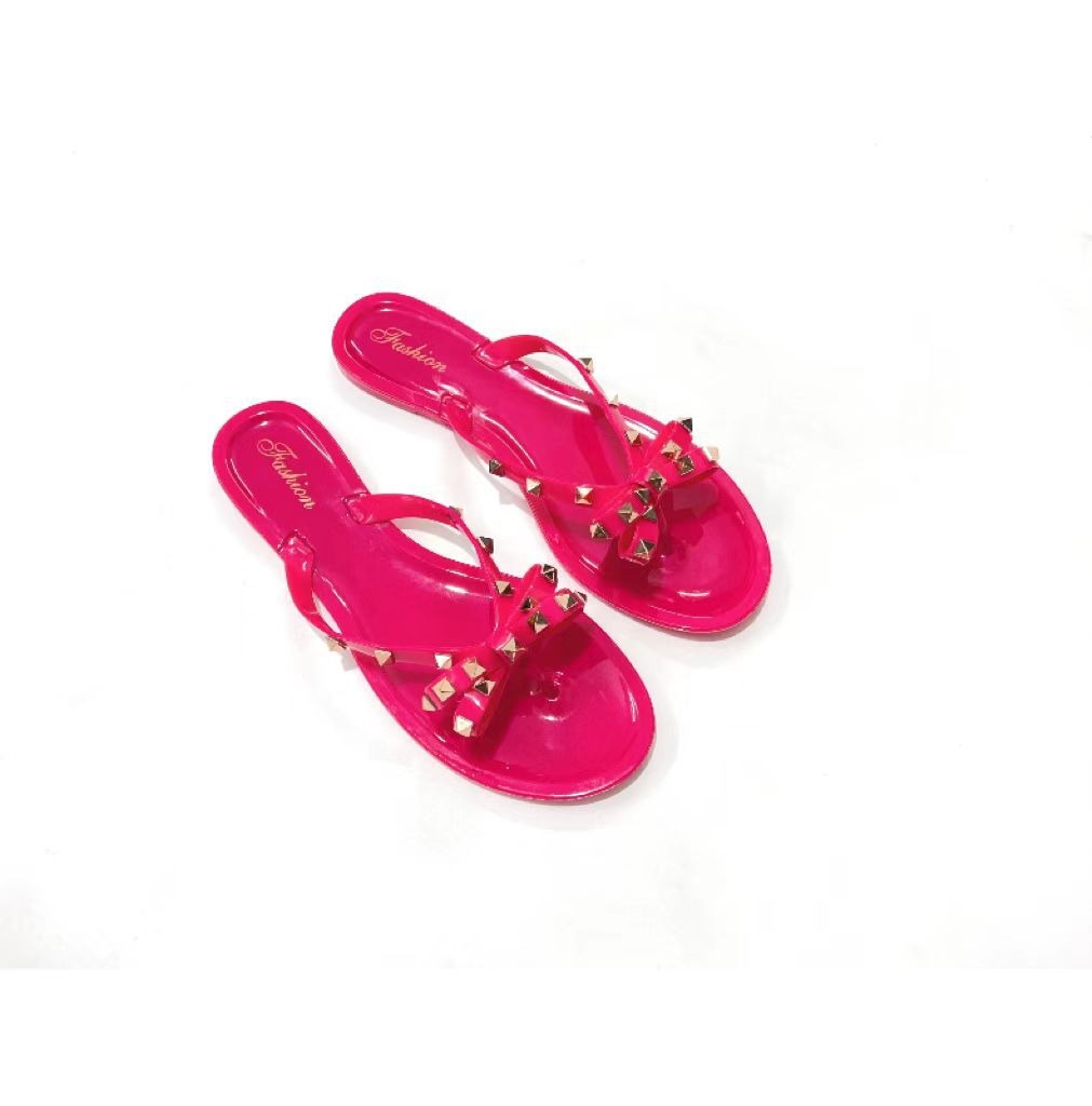 New style rivet shoes, bow shaped flip flops, summer beach outings, flat bottomed transparent jelly crystal slippers for women